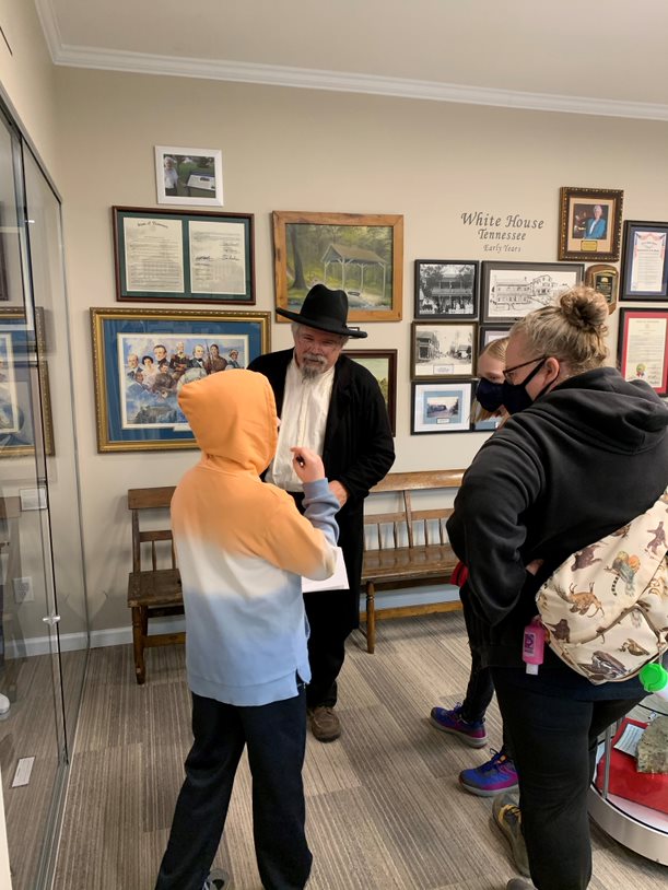 homeschool group listening to volunteer reenactor