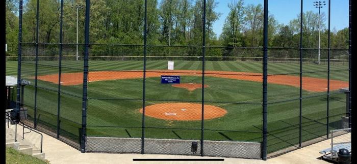 Municipal park baseball field from behind home plate fence