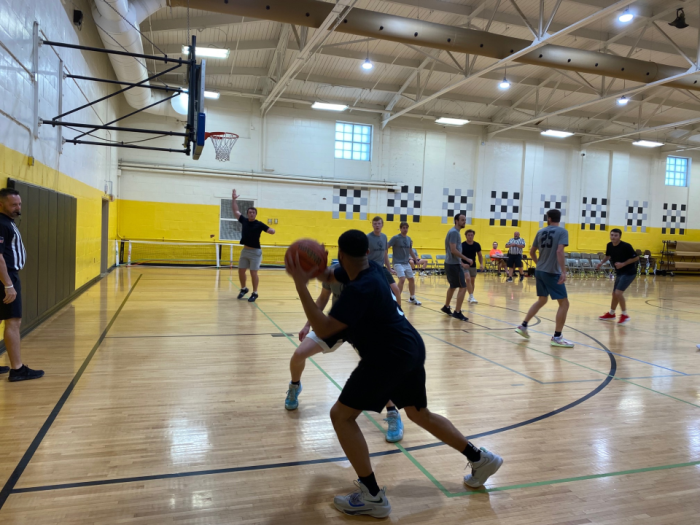 Basketball player looking for a pass along the baseline.