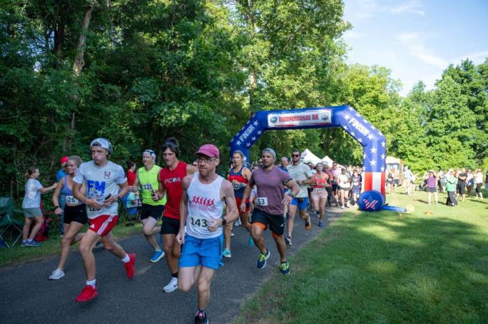 Runners coming off the start line at the independence day 5k