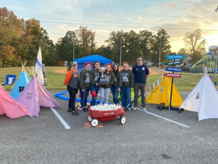 Trail of Treats Deocration Winner's from Summit Preparatory Academy in front of color teepees and fake fire pit display